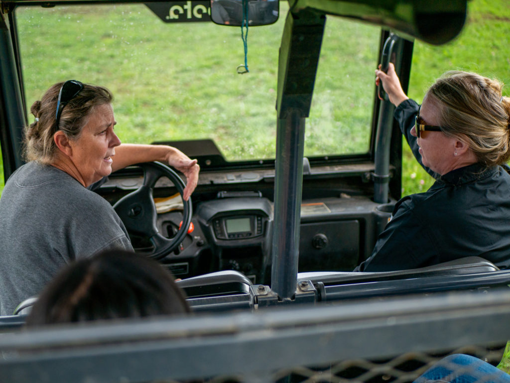 Farmer talking to a researcher inside a utility vehicle